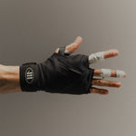 Close-up of a man's hand wearing black 'M' Logo boxing hand wraps