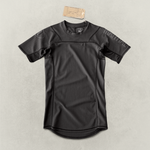 Black Martial rashguard laying on a light gray backdrop.