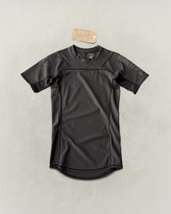 Black Martial rashguard laying on a light gray backdrop.