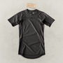 Black Martial rashguard laying on a light gray backdrop.